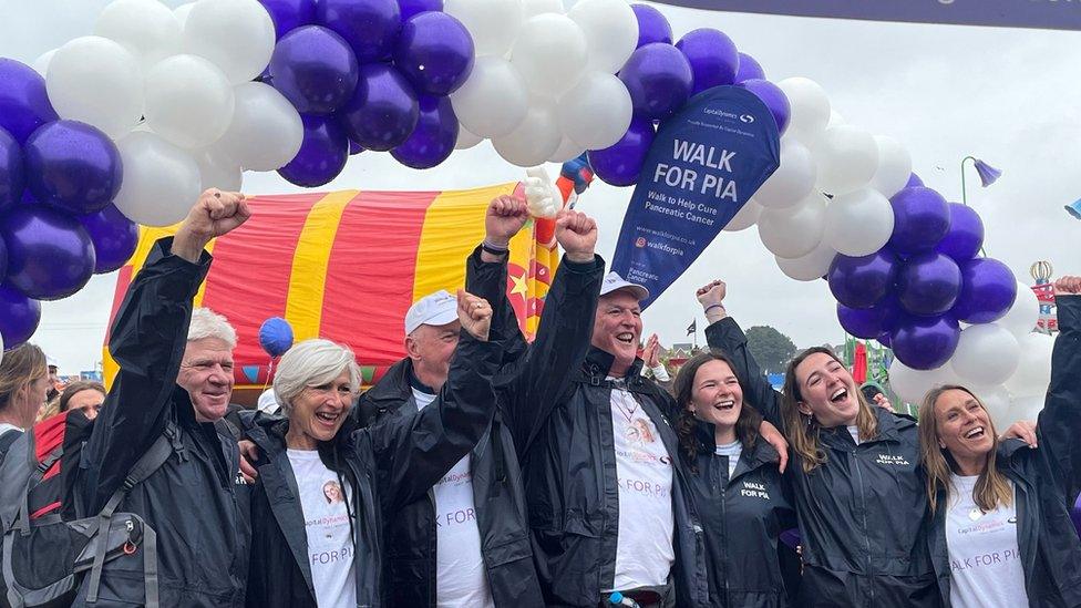 walkers celebrate at the finish line