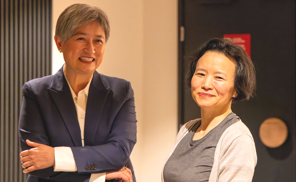 Australian Foreign Minister Penny Wong (L) meets Australian journalist Cheng Lei (R) on arrival at Melbourne Airport on 11 October