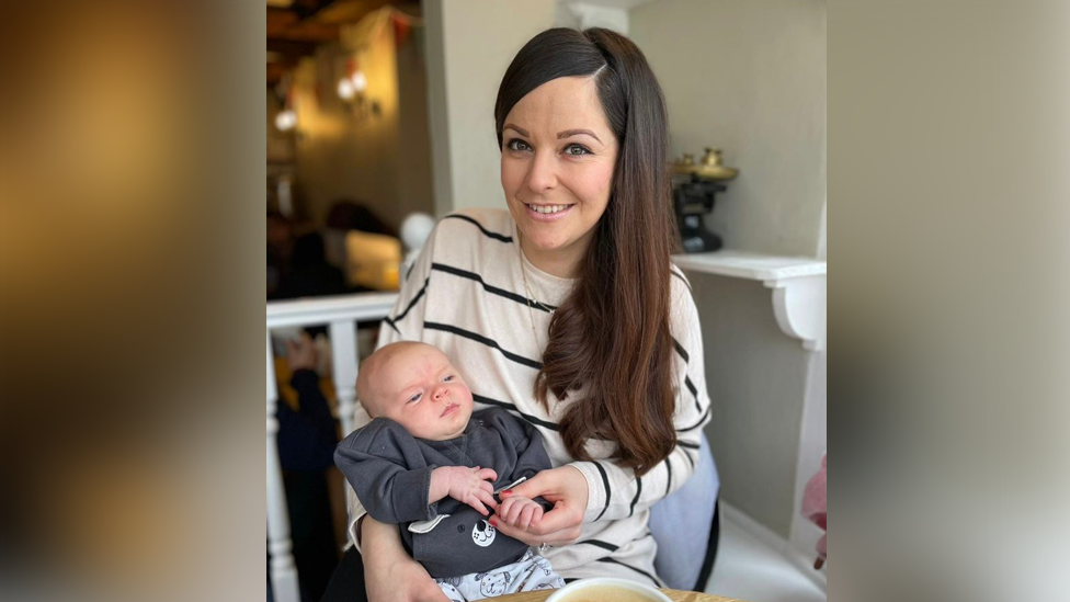 Natalie holding her baby son Arthur