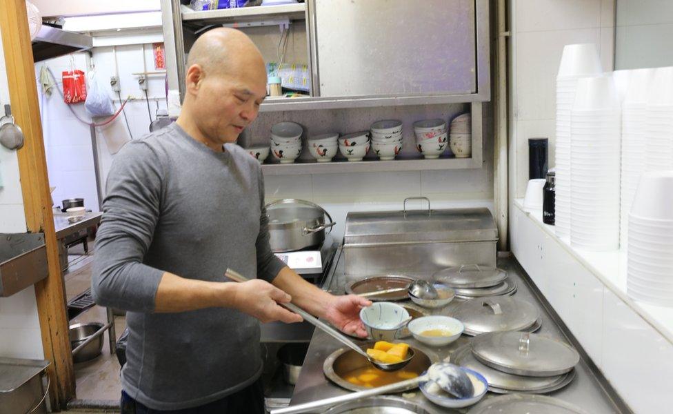 Chiu Wai Yip preparing food at his restaurant