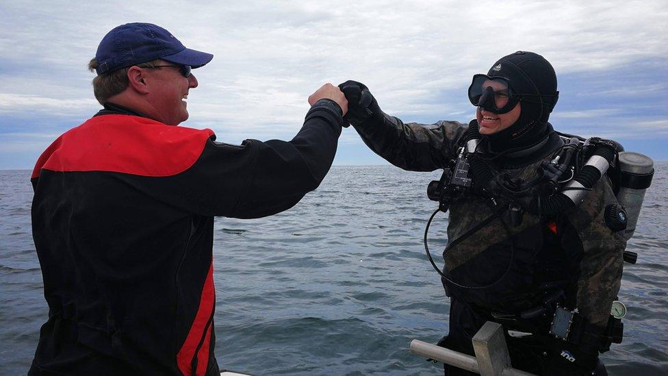 Ryan King and Jeff Goodreau celebrate after their initial discovery of the Eagle 56