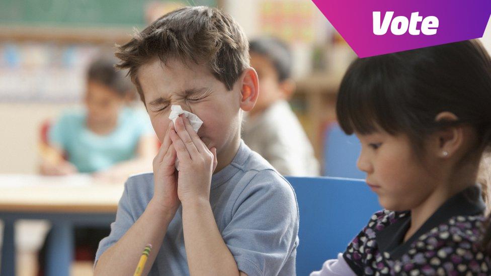 Boy sneezing in class