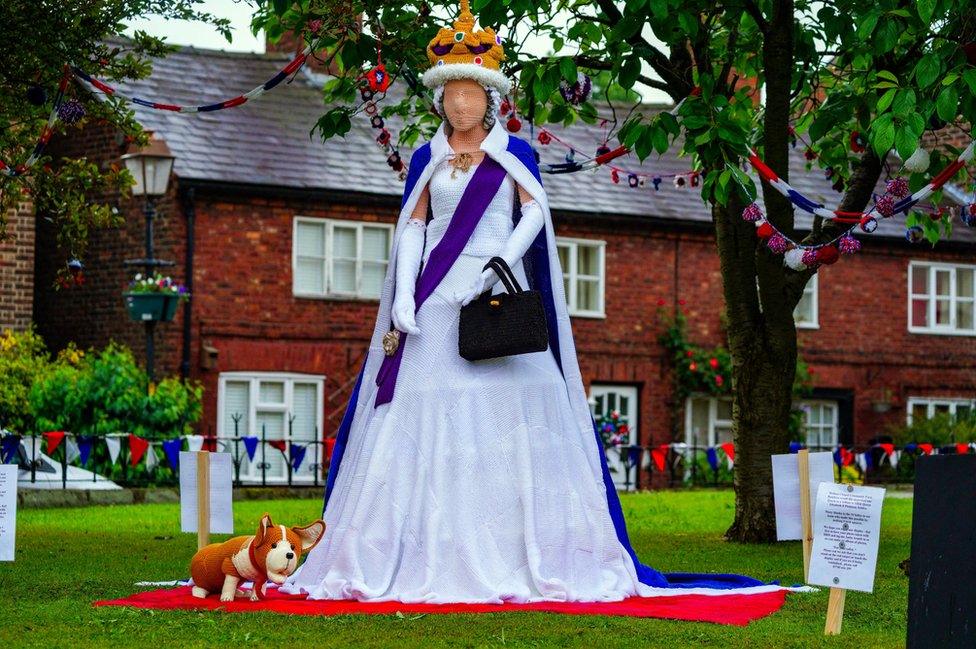 A life size knitted Queen and corgi in the village of Holmes Chapel