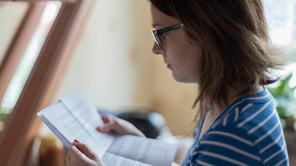 Woman reading bill