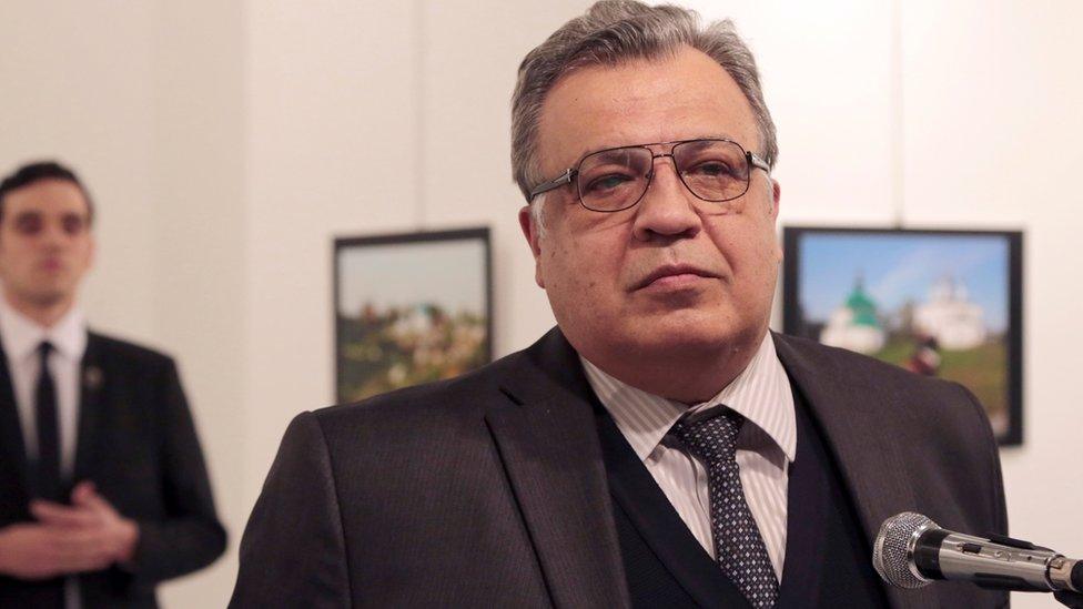 The gunman named as Mevlut Mert Altintas is pictured behind Andrei Karlov, Russian ambassador to Turkey, moments before he shot him dead in the back on 19 December 2016