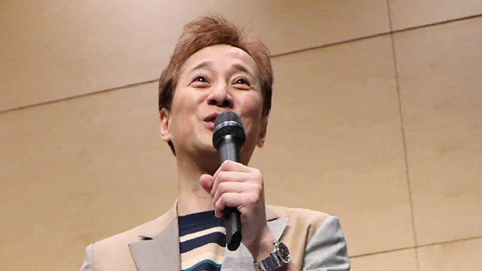 Masahiro Nakai pictured with a mic at an event