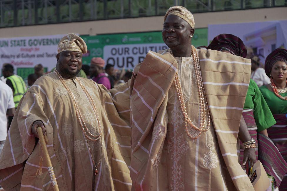 Two men in matching traditional outfits.