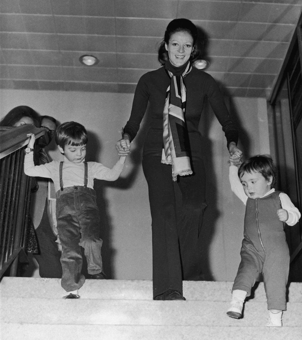 English actress Maggie Smith with her two children, Chris Larkin (left) and Toby Stephens, at London Airport, March 1971.