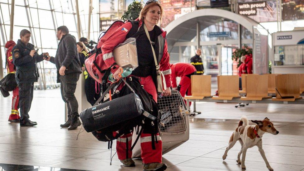 A female firefighter and her rescue dog arriving at a Turkish airport