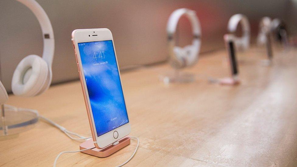 iPhones on display in an Apple store