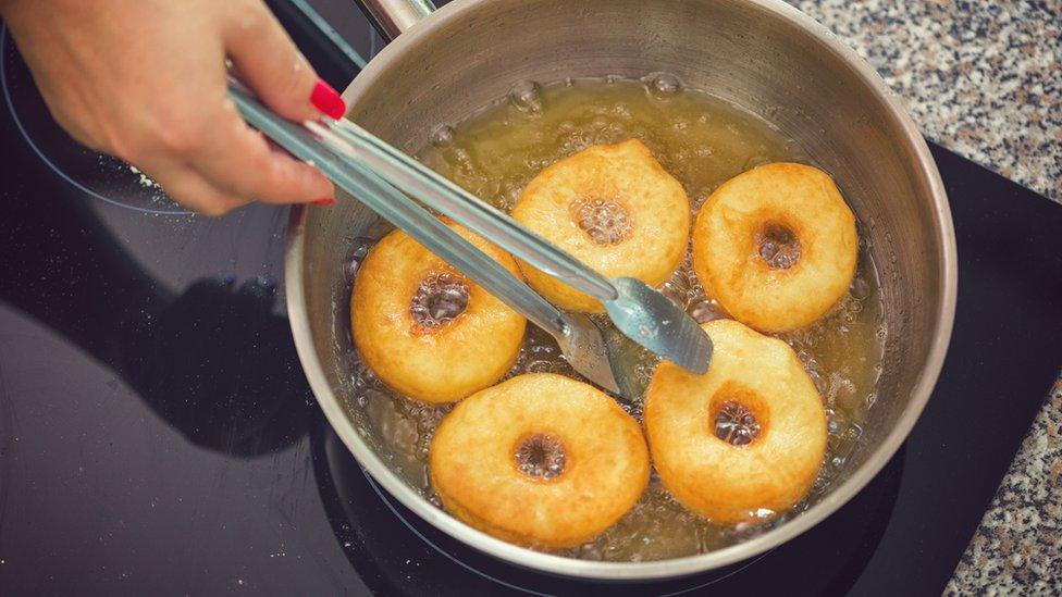 Doughnuts cooking in oil