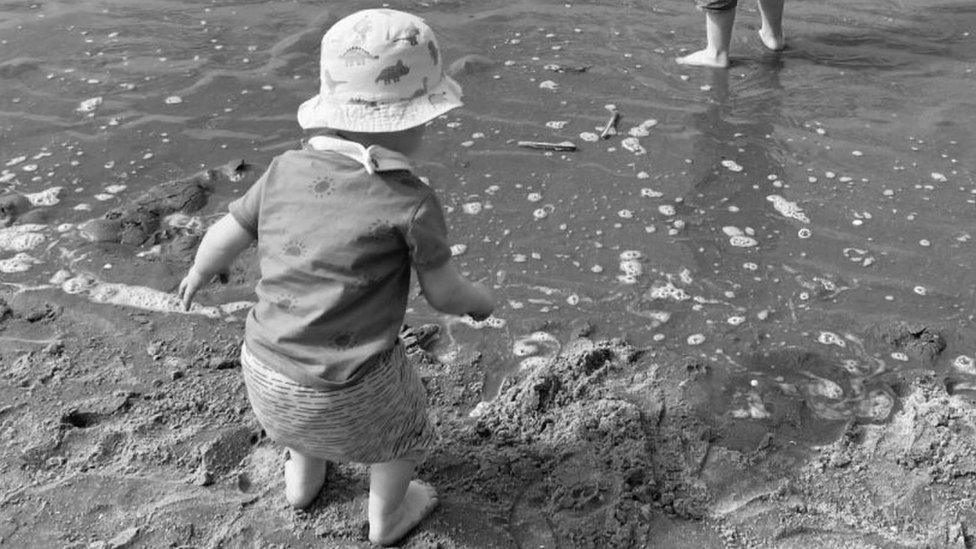 Blurred beach photo of baby George