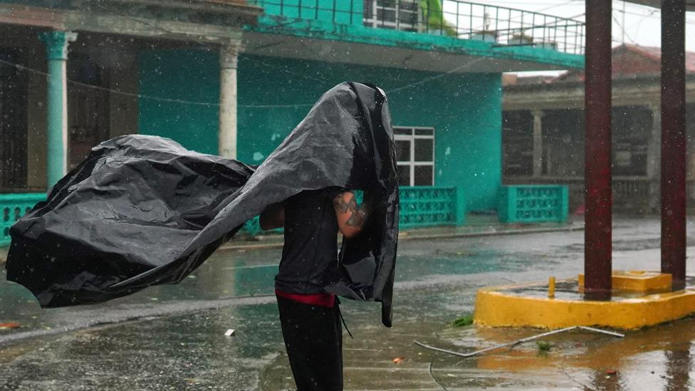 A man runs on the streets as Hurricane Ian passes through Pinar del Rio, Cuba, on 27 September 2022