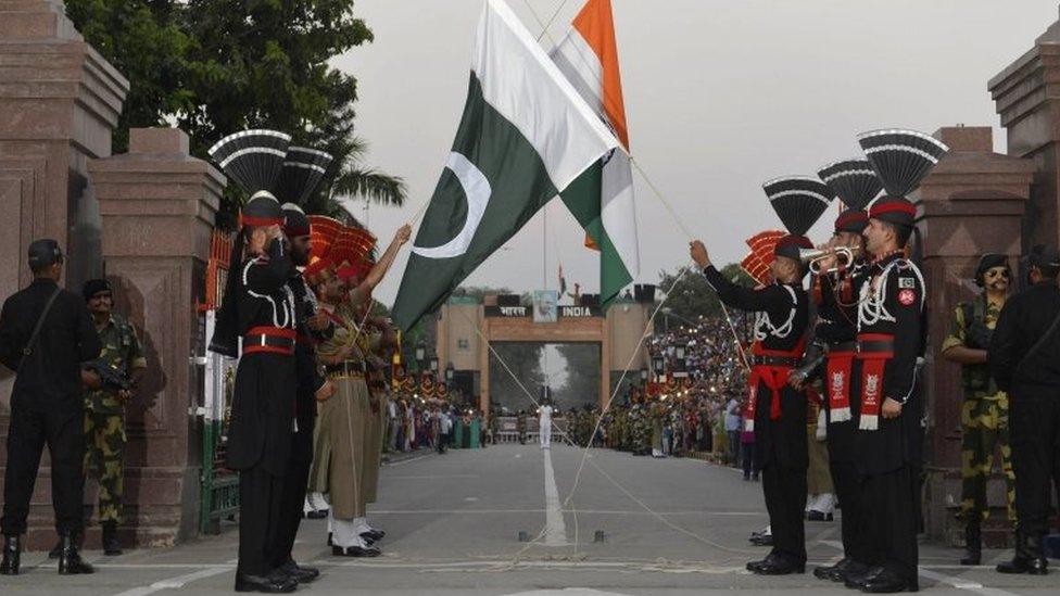 Pakistani Rangers (in black) and Indian Border Security Force (BSF) personnel perform the flag off ceremony at the Pakistan-India Wagah Border on September 12, 2015