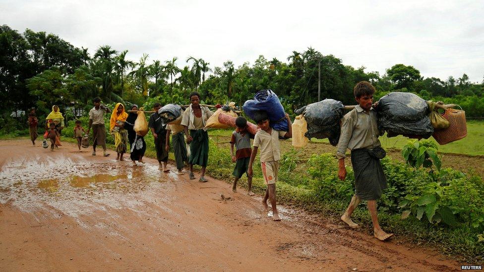 Rohingyas walk along the road to reach to the refugee camp after crossing the border in Cox"s Bazar