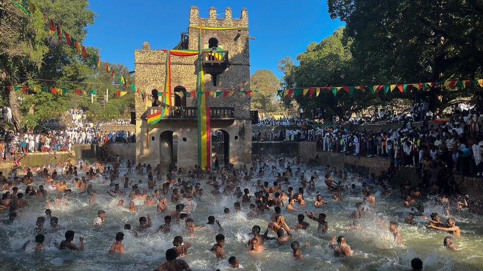 Attendees get baptised in a huge outdoor pool