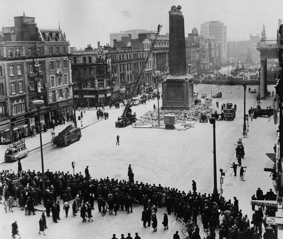 Crowds gather to watch the removal of the stump of Nelson's Pillar