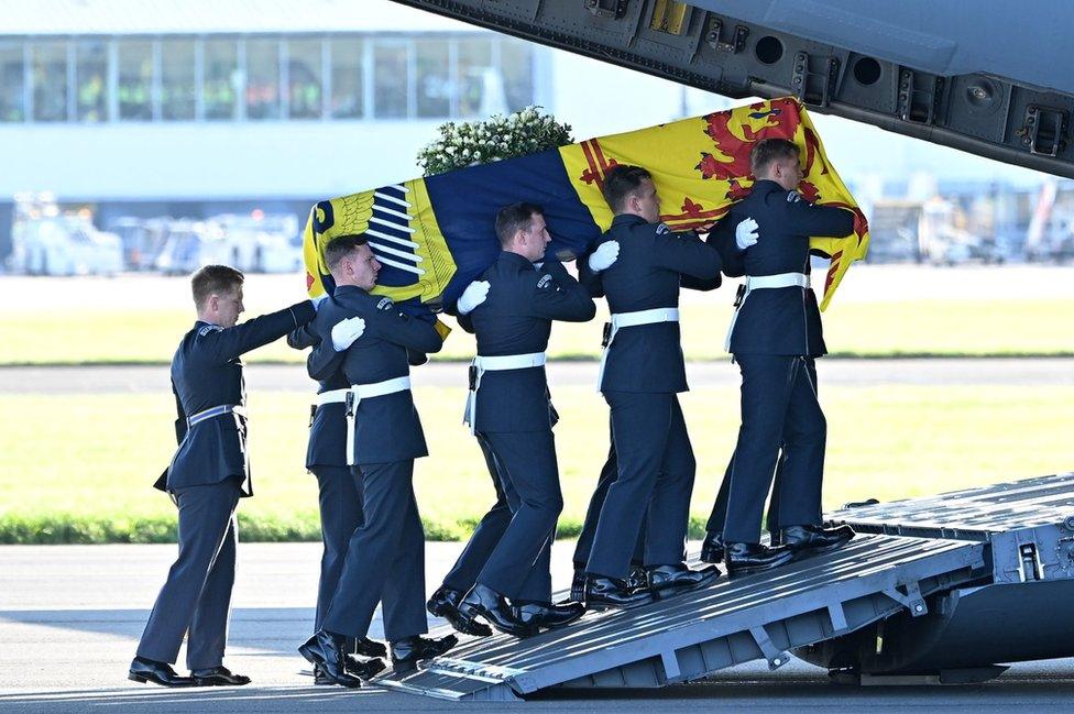 The Queen's coffin is carried onto the plane