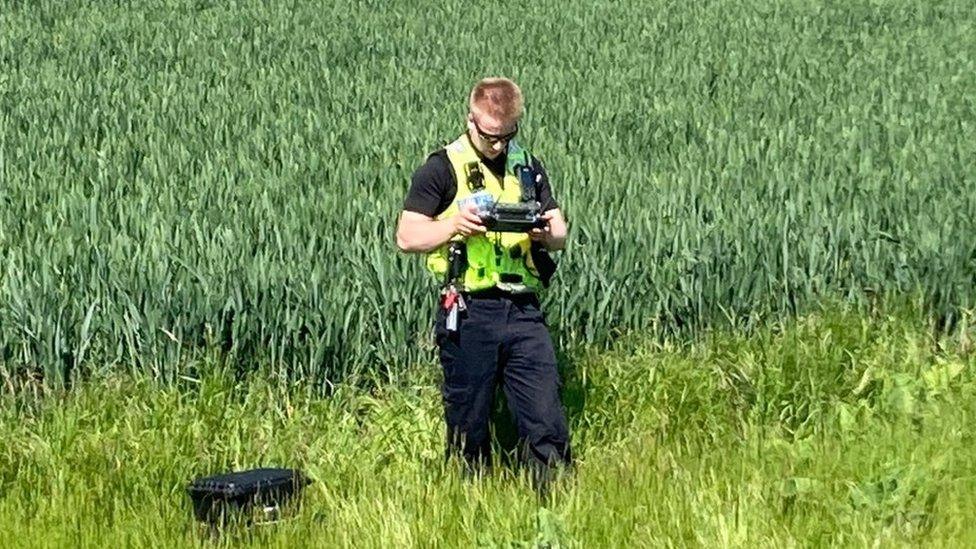 Police officer flying a drone