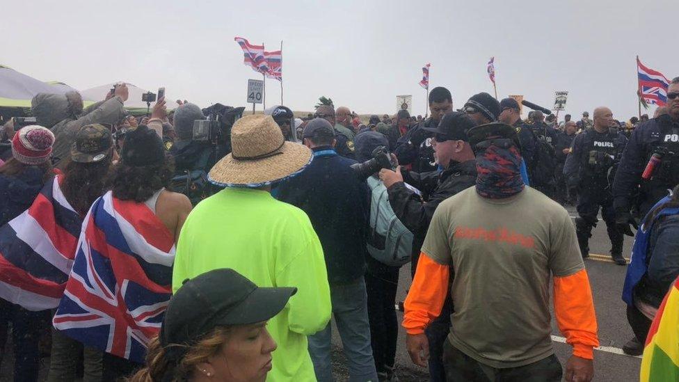 Protesterers led by native Hawaiian elders take part in a protest against the building of a giant new telescope on what they consider sacred ground at the summit of Mauna Kea volcano