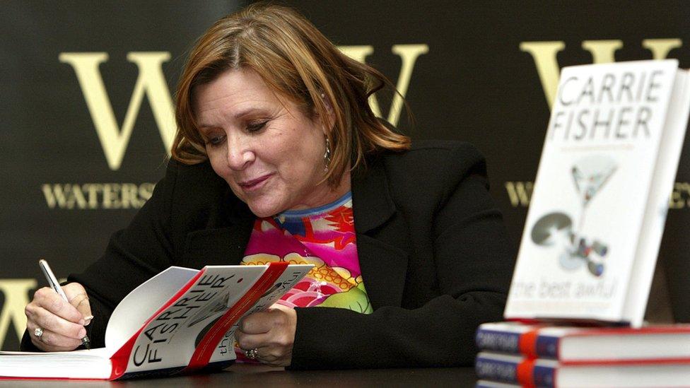 Carrie Fisher signs her book The Best Awful at a promotional event in London on 20 Feb 2004