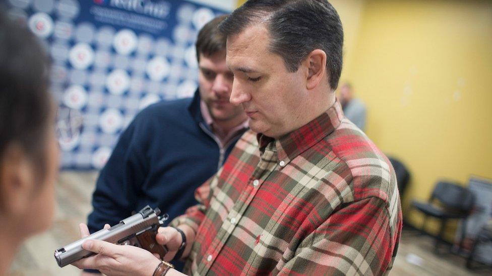 Ted Cruz inspects a handgun at a campaign event.