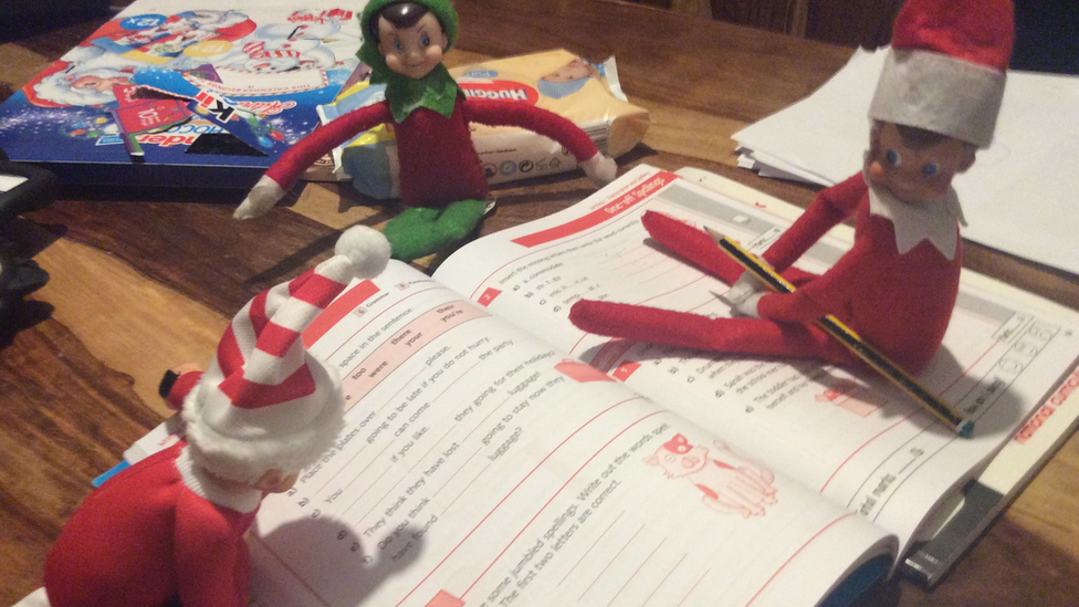 Elves doing homework