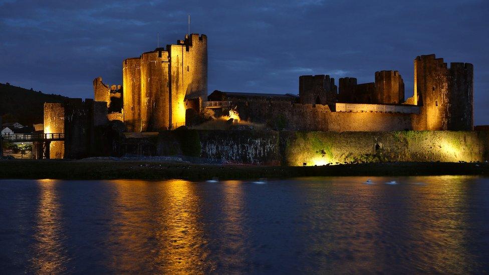 Caerphilly Castle lit up yellow