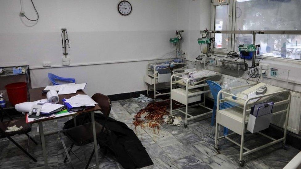 Blood smeared on the floor of the hospital near some cribs