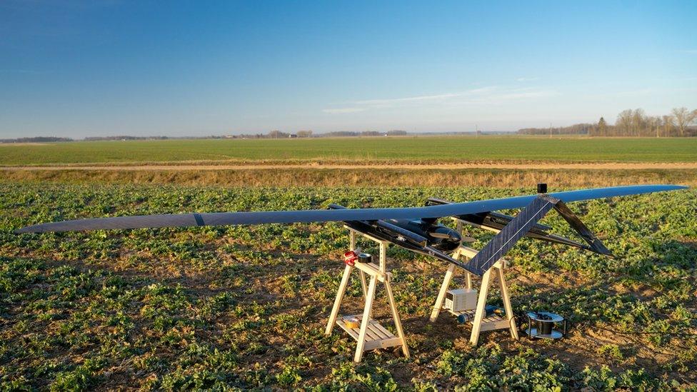 The UAV is seen on a stand in a farmer's field in this photo