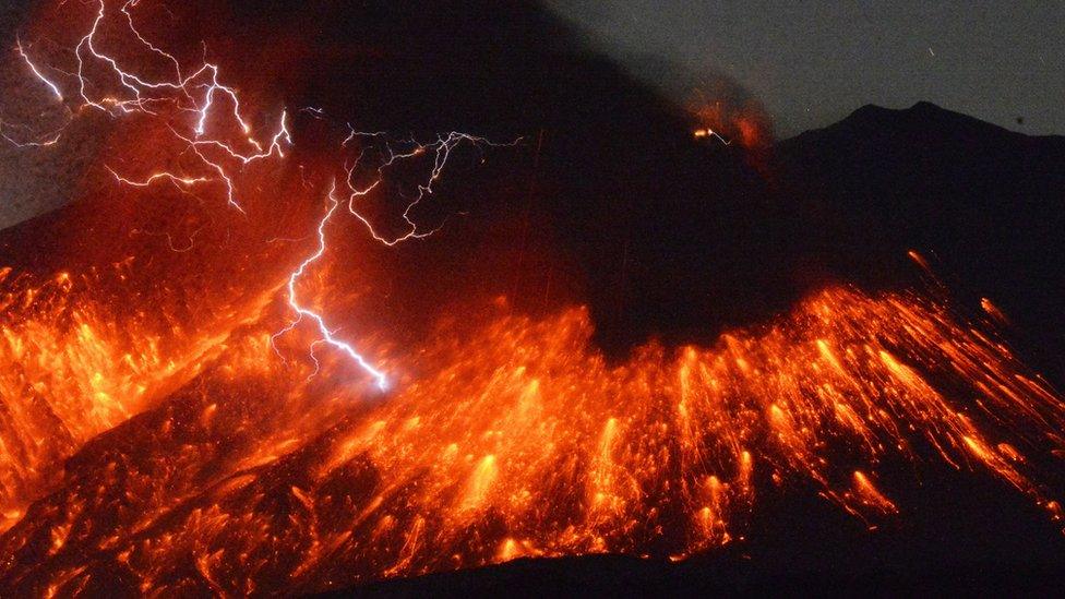 Lightning flashes above flowing lava as Sakurajima, a well-known volcano, erupts Friday evening in southern Japan.