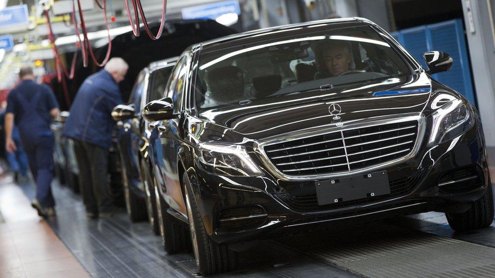 An employee of the Mercedes-Benz AG checks a S-Class model at the plant in Sindelfingen, Germany.