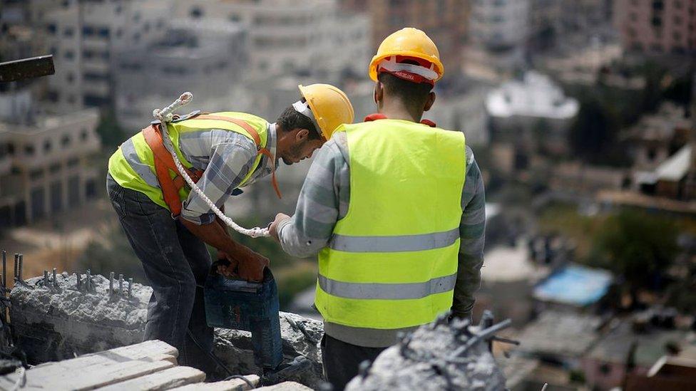 Palestinian workers on damaged building in Gaza (file photo)