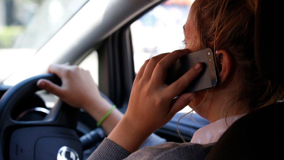 A woman on her mobile phone - posed by model