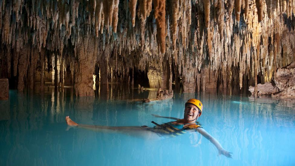 Tourist in an underground river in Xcaret