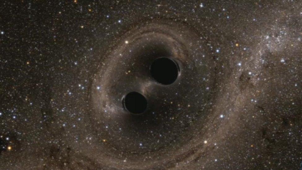 Artists impression of two black holes locked in a “death spiral”