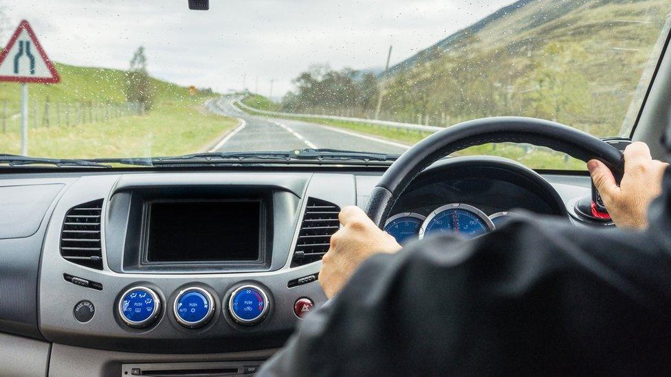 Hands on a steering wheel