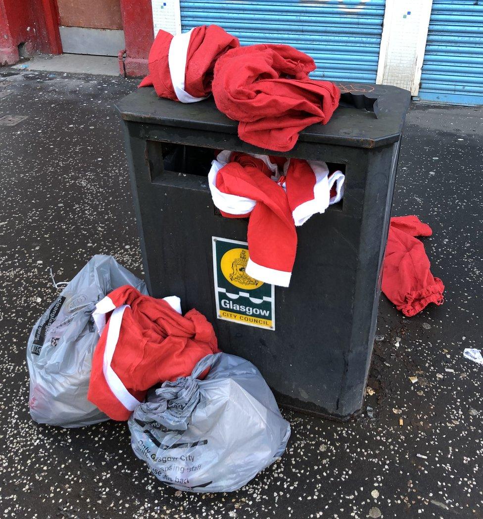 Santa costumes in bins