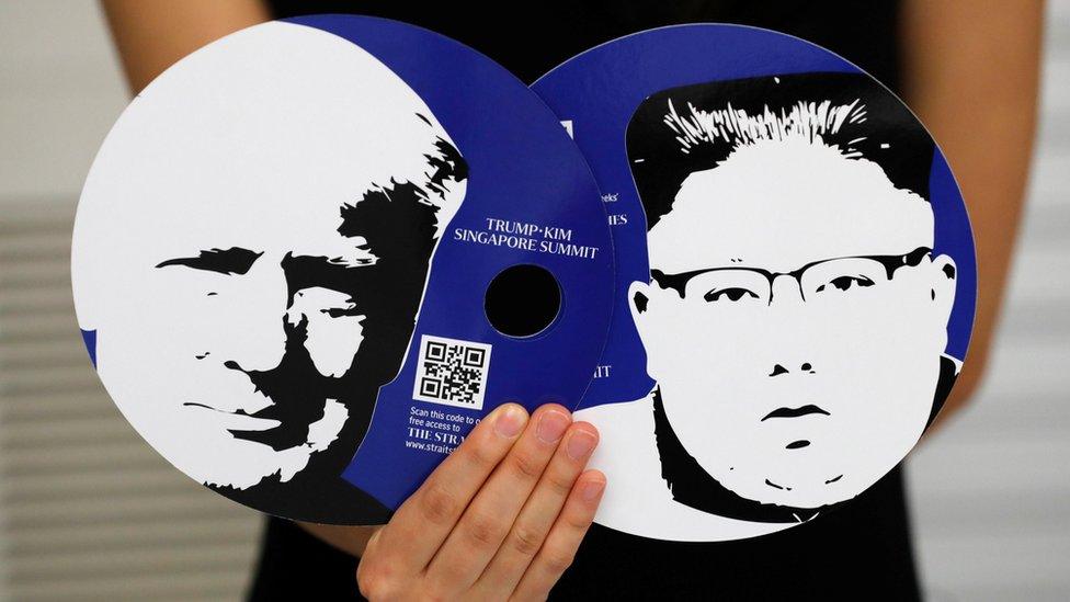 fans featuring the images of U.S. President Donald Trump (L) and North Korean leader Kim Jong Un