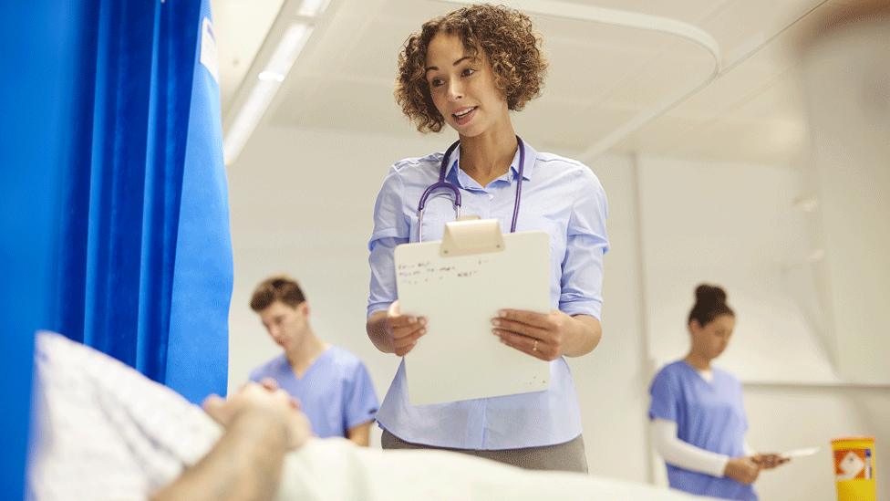 Doctor and patient in hospital ward