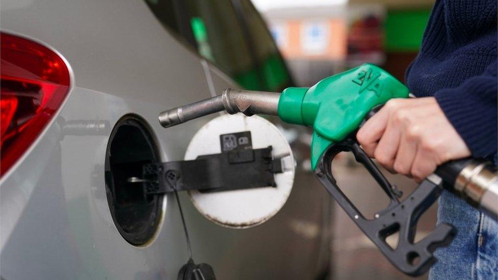 Person filling car at petrol pump