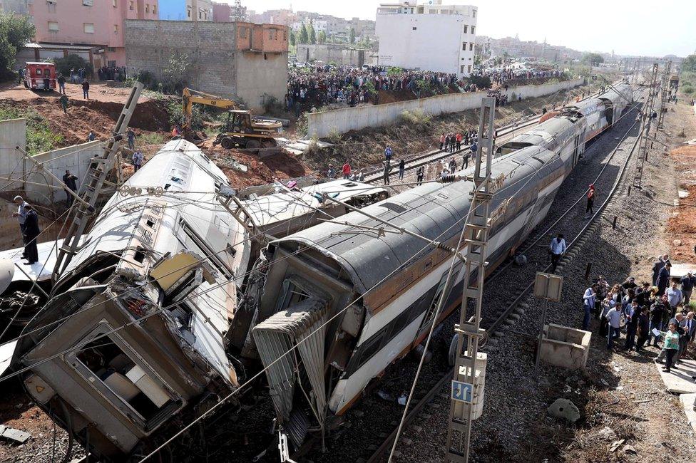 Security personnel are seen at the site of a train derailment