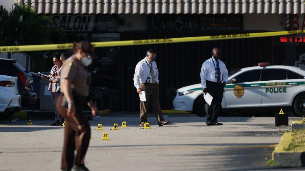 Officers examine the scene of a shooting outside a banquet hall in Hialeah, Florida