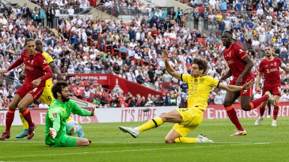 Chelsea's Marcos Alonso has a shot on goal saved by Liverpool's Alisson Becker