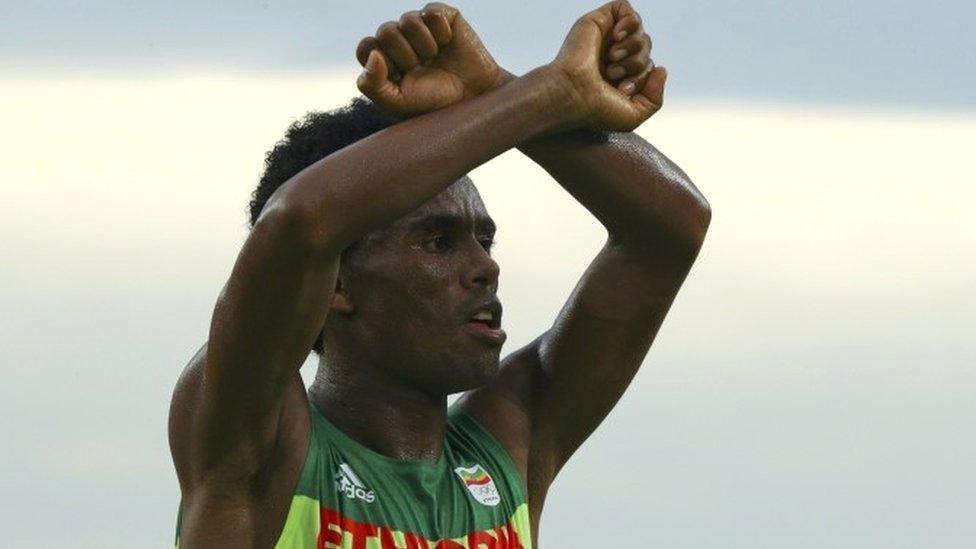 Ethiopian runner Feyisa Lilesa making a Oromo protest gesture at the Olympics