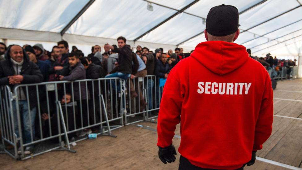 Asylum seekers queuing in Germany