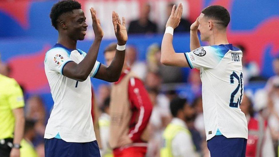 England's Bukayo Saka is congratulated by Phil Foden after being substituted during the UEFA Euro 2024 Qualifying Group C match at Old Trafford