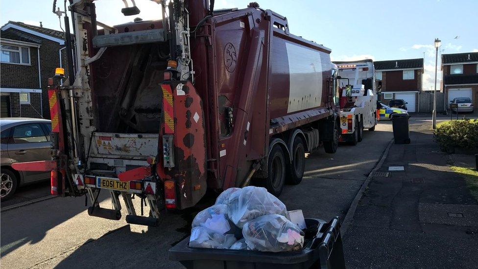 Bin lorry being towed away