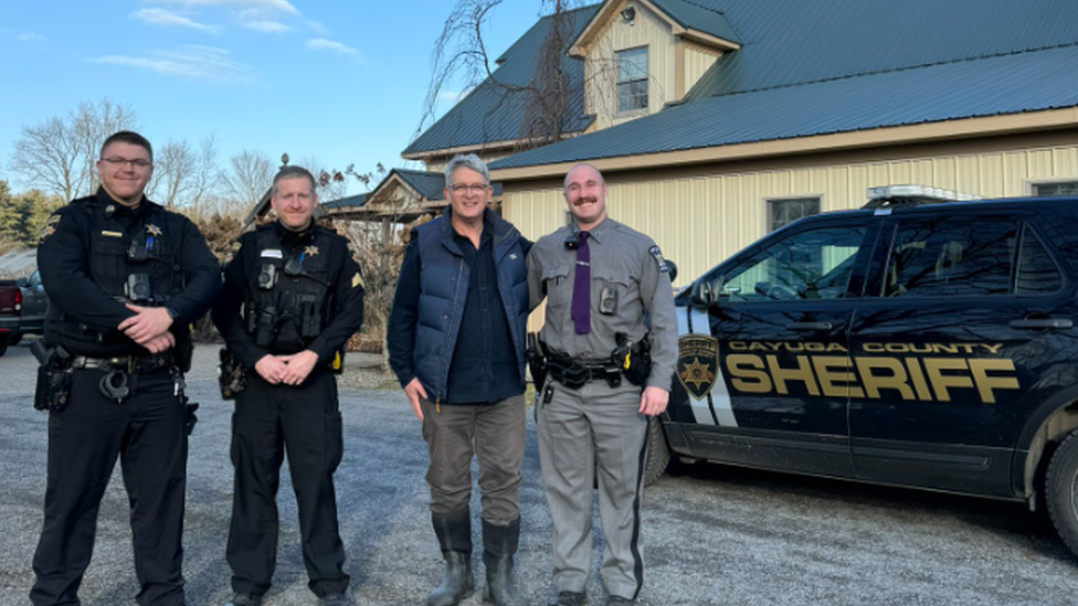 Congressman Brandon Williams (third from left) with police officers outside his home