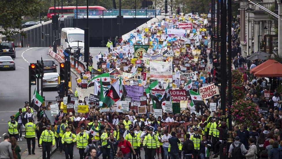 Hundreds of people marching with placards at the Refugees Welcome demonstration.